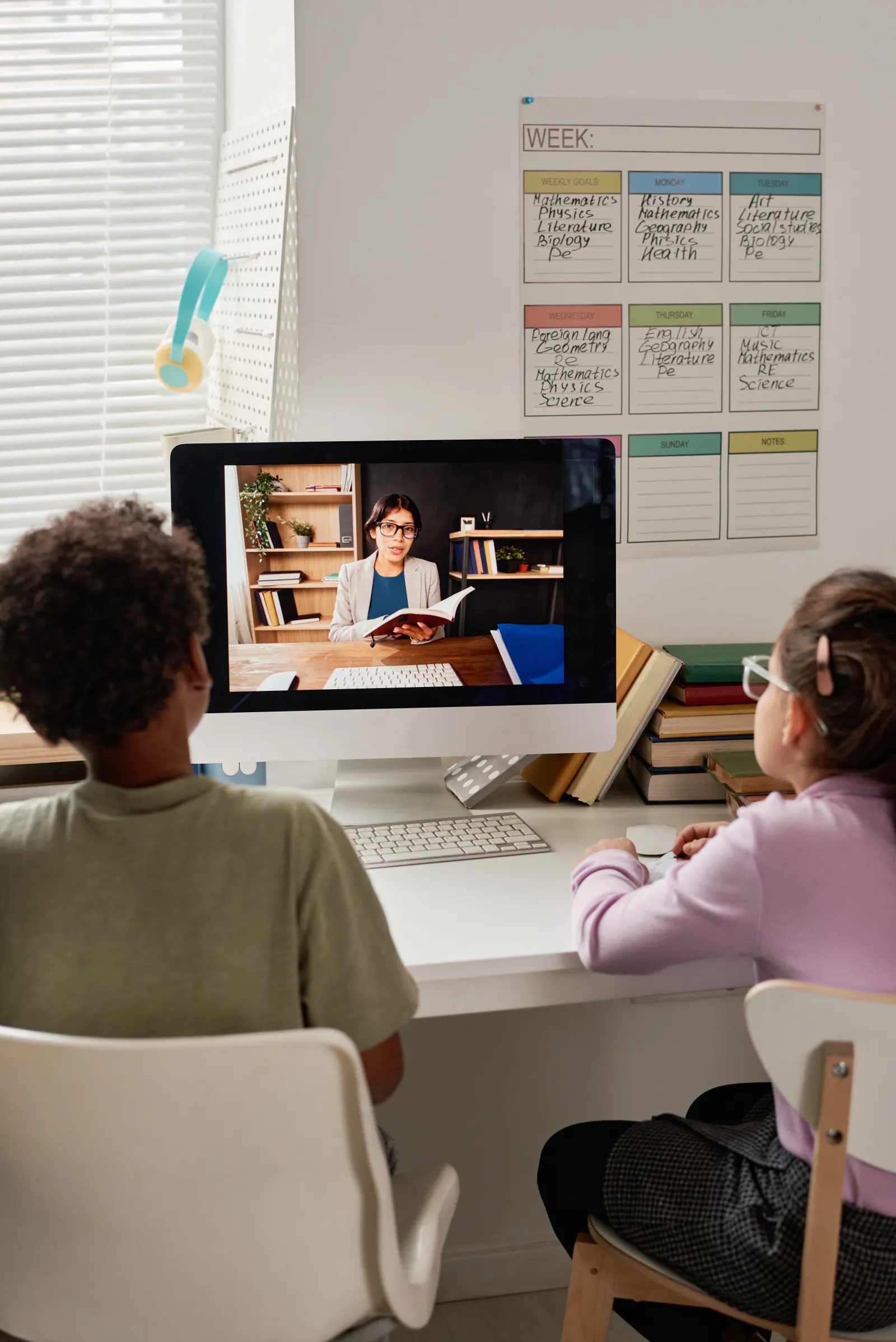 Two kids studying with an online tutor